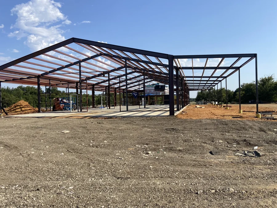 Wide clear-span steel building frame supplied by Metal Warehouse Inc. in North Texas
